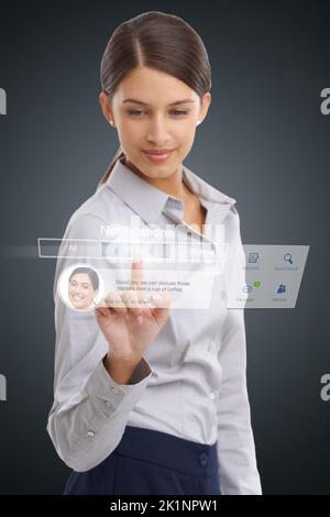 Checking her notifications. woman using a digital interface to access her social media networks. Stock Photo