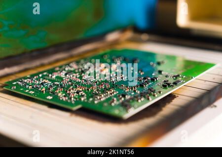 Reflow soldering furnace used on mounted PCB printed circuit board. Assembling electrical components. Modern technology. Horizontal close-up shot. High quality photo Stock Photo