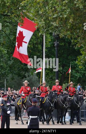 London, UK, 19th September, 2022. Canandian mounted officers ride in the ceremonial procession for Her Majesty the Queens's state funeral, after her passing on the 8th September, with burial to take place at Windsor Castle. Credit: Eleventh Hour Photography/Alamy Live News