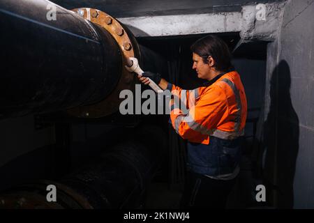 Workers installing water supply pipeline system, close up. Stock Photo