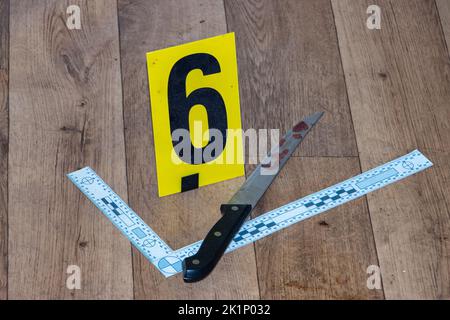 Proof marked with a number - bloody knife at the scene of the crime Stock Photo