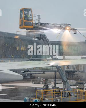 HELSINKI, FINLAND, FEB 15 2022, A aircraft de-icing (anti-icing) using ...