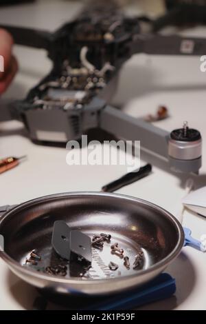 close up of different repairing tools and a drone, on white table Stock Photo