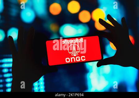 In this photo illustration the Indian Multinational Crude Oil and Gas  company, ONGC, logo seen displayed on a smartphone with USD (United States  dollar) currency in the background Stock Photo - Alamy