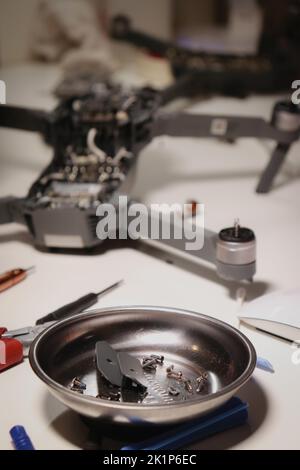 close up of different repairing tools and a drone, on white table Stock Photo