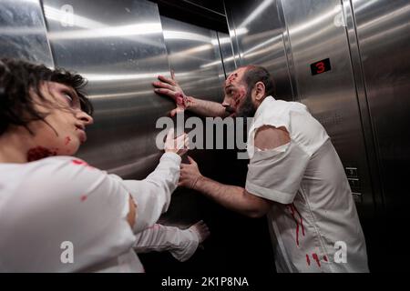 Brain eating monsters crawling in elevator to escape and attack people, walking dead massacre with creepy devil zombies. Horrific eerie corpses with wounds and scars, undead abusive violence. Stock Photo