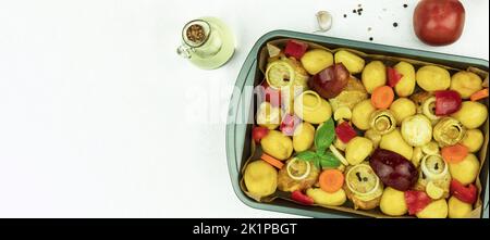 On a metal baking sheet of meat with spices. Background with space for text. The process of cooking meat with potatoes in the oven Stock Photo