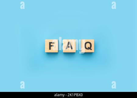 FAQ frequently asked questions text on wooden blocks. Quiz, test, survey, interrogation, support, knowledge and decision. FAQ information sign banner Stock Photo