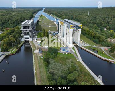 14 September 2022, Brandenburg, Niederfinow: The old (l) and the new (r) ship lift (aerial view with a drone). The dimensions of the new ship lift are enormous. The trough, in which the ships can travel up or down the approximately 36 meters in the elevator, weighs 9800 tons. After around 14 years of construction, the inauguration of the giant ship lift is now scheduled for October 4, 2022. The Federal Waterways and Shipping Administration has invested around 520 million euros in the new lift. The new facility will then be available for general shipping traffic from 05.10.2022. The old ship li Stock Photo