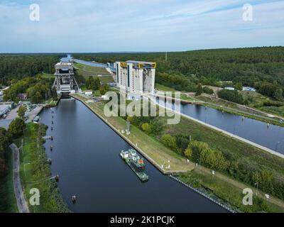 14 September 2022, Brandenburg, Niederfinow: The old (l) and the new (r) ship lift (aerial view with a drone). The dimensions of the new ship lift are enormous. The trough, in which the ships can travel up or down the approximately 36 meters in the elevator, weighs 9800 tons. After around 14 years of construction, the inauguration of the giant ship lift is now scheduled for October 4, 2022. The Federal Waterways and Shipping Administration has invested around 520 million euros in the new lift. The new facility will then be available for general shipping traffic from 05.10.2022. The old ship li Stock Photo