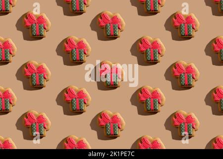 Holiday bakery seamless pattern. Festive decorated gift pastry. Homemade colorful icing gingerbread present box cookies isolated on beige pastel. Stock Photo