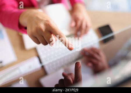 Female hands pointing finger at screen on monitor Stock Photo