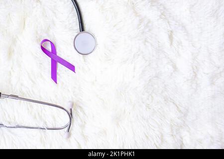 Pancreatic Cancer, world Alzheimer, epilepsy, lupus and domestic violence day Awareness month, Woman holding purple Ribbon with stethoscope. Healthcar Stock Photo