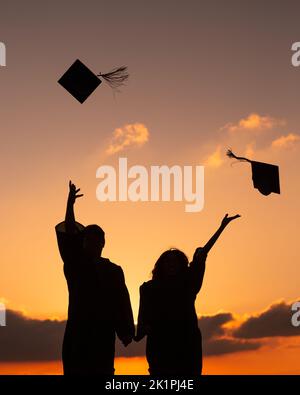 happy students throwing graduation caps in the Air Stock Photo - Alamy