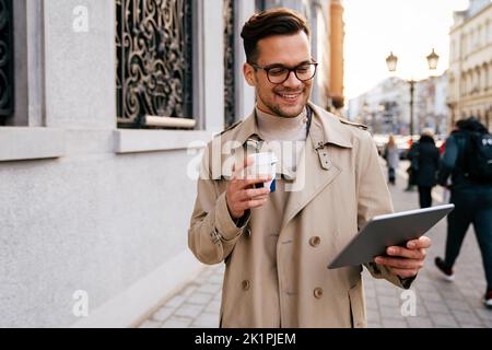Portrait of a successful man using digital tablet during quick break in urban background Stock Photo