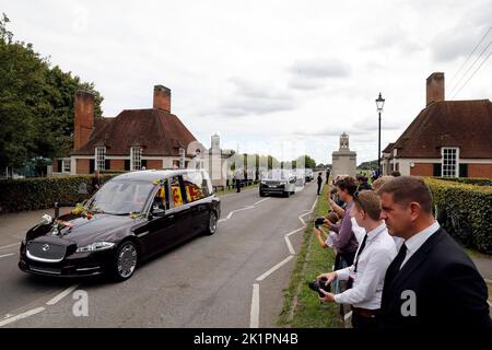The State Hearse carries the coffin of Queen Elizabeth II, draped in the Royal Standard with the Imperial State Crown and the Sovereign's Orb and Sceptre, as it travels through Runnymede on its journey from the State Funeral at Westminster Abbey, London, to a Committal Service at St George's Chapel in Windsor Castle, Berkshire. Picture date: Monday September 19, 2022. Stock Photo