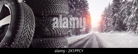 winter tires with a good tire profile on the wintry landscape with snow-covered roads Stock Photo