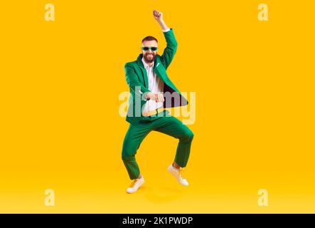 Cheerful energetic man has fun dancing in gangnam style at St. Patrick's Day party. Stock Photo