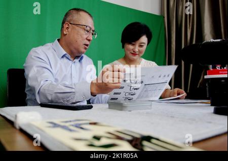 ZHANGJIAKOU, CHINA - SEPTEMBER 20, 2022 - Technicians of Huatai Mining, Metallurgy and Machinery Co LTD exchange technical issues with customers via a Stock Photo