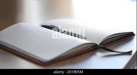 Office mockup notebook and pen on a desk for work, writing or planning a schedule. Professional, empty and Isolated texture book, diary or notepad Stock Photo
