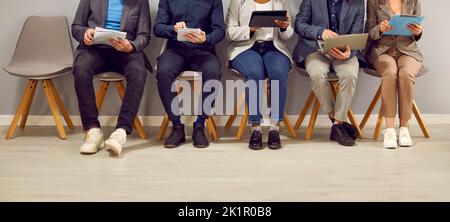 People using laptop and tablet computers while waiting for business meeting or job interview Stock Photo