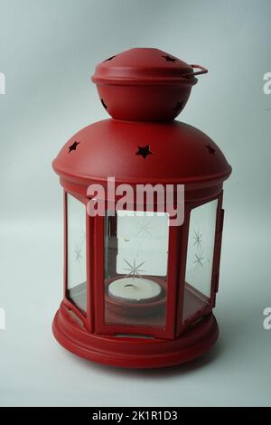 Ornamental Arabic lantern with burning candle glowing in hand. Stock Photo