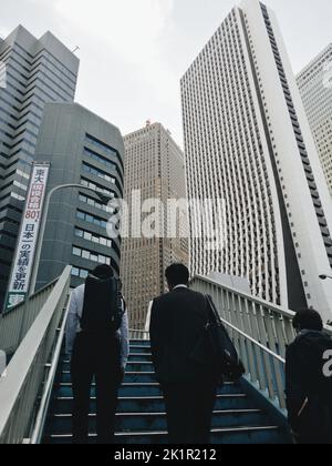 A vertical shot of workers going to their offices in Tokyo Stock Photo