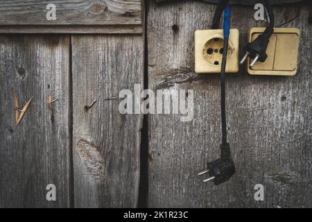 Old socket. Switch and socket. Broken electrical appliances. Dangerous wires. Stock Photo