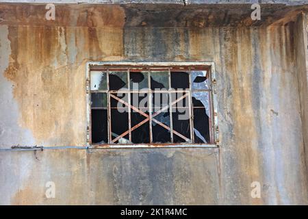 Window with broken windows in an abandoned house. Stock Photo