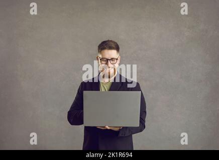Caucasian businessman using laptop for online business, remote education Stock Photo