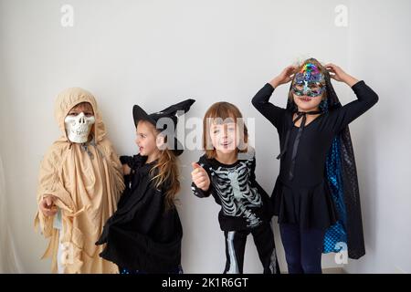 Kids in Halloween costumes on white background Stock Photo