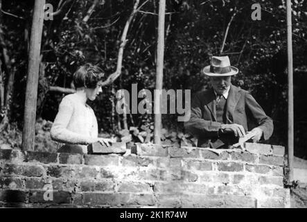 Winston Churchill bricklaying at Chartwell, assisted by his daughter, Sarah. 1928 Stock Photo
