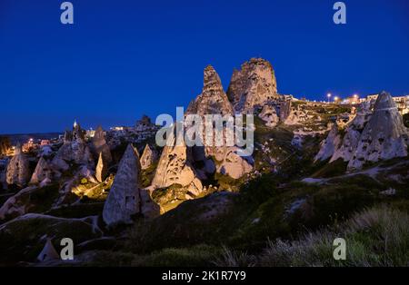 Uchisar castle, Twilight photo of the perforated castle rock of Uçhisar, Goreme, Cappadocia, Anatolia, Turkey Stock Photo