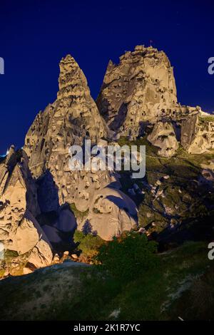 Uchisar castle, Twilight photo of the perforated castle rock of Uçhisar, Goreme, Cappadocia, Anatolia, Turkey Stock Photo