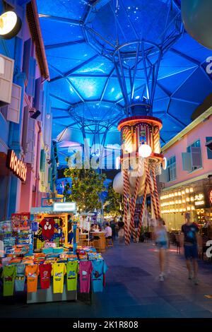 Clarke Quay on Singapore River illuminated by coloured lights with night life, restaurant.  Clarke Quay Singapore Stock Photo