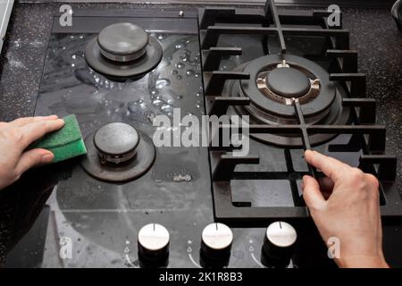 Cleaning Glass Ceramic Stove By Sponge And Detergent From Spray Bottle 