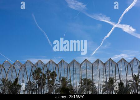 Contrails in shape of X over canopy of Umbracle gardens at City of Arts and Sciences in Valencia, Spain in September Stock Photo