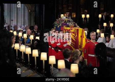 The coffin of Queen Elizabeth II, followed by King Charles III and the Queen Consort, is carried by the Bearer Party into the Committal Service for Queen Elizabeth II held at St George's Chapel in Windsor Castle, Berkshire. Picture date: Monday September 19, 2022. Stock Photo