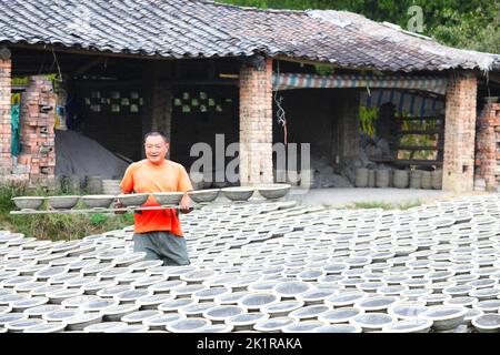 CHONGQING, CHINA - SEPTEMBER 19, 2022 - A view of clay pottery fired by a master in Chongqing, China, Sept 19, 2022. Sand pottery is made of local uni Stock Photo