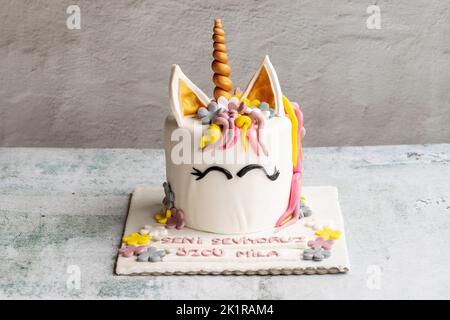 Special design cake in the shape of a unicorn. Design birthday cake on gray background Stock Photo