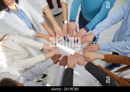 Top view multiracial team peoples outstretched hands standing in circle symbolizing inclusive Stock Photo