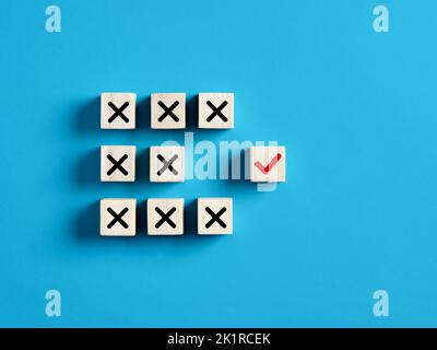 Checkmark and cross icons on wooden cubes. Separate the right from wrong, right choice or decision, voting yes or no concept. Stock Photo