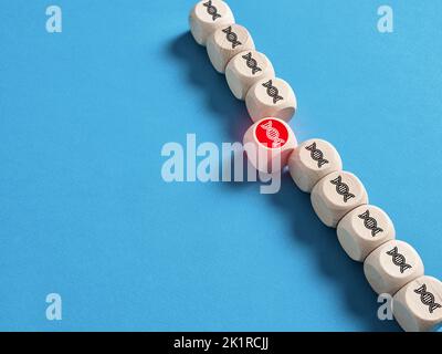 DNA molecule symbols on wooden cubes. Damaged strand of DNA chain. DNA mutation and genetic disease, cancer. Stock Photo