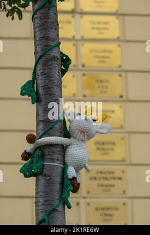 Lublin, Poland - June 05, 2022: Soft handmade goat doll and vine branch on the tree. Goat - the mascot of the Lublin City Stock Photo