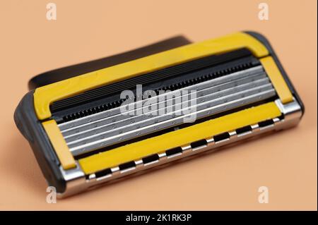 Sharp razor blade cassette  macro close up view on brown background Stock Photo
