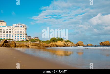 a view of the La Grande Plage Beach in Biarritz, France, with the Rocher du Basta rock formation on the right, early in the morning in a summer day Stock Photo