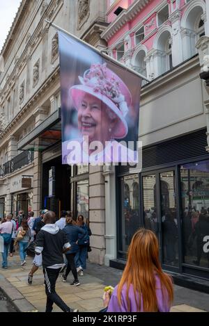 Piccadilly, London, UK, 19th September 2022. On the state funeral of Her Majesty Queen Elizabeth II. Picture tribute of Her Majesty the Queen flag. Stock Photo