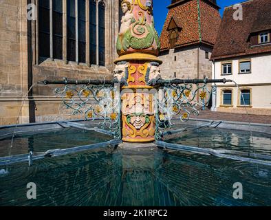 In front the Lion fountain (Lowenbrunnen), in the back a detail of the exterior of the Heilig-Kreuz-Muenster minster, Schwabisch Gmund, Baden-Wuerttem Stock Photo
