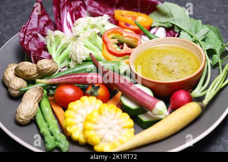 vegetable salad and bagna cauda (a garlic and anchovy sauce for dipping vegetables) Stock Photo