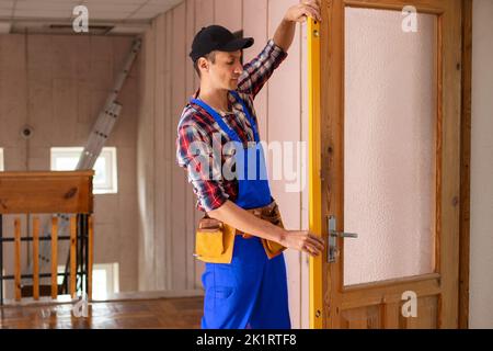 handyman repair the door lock in the room Stock Photo